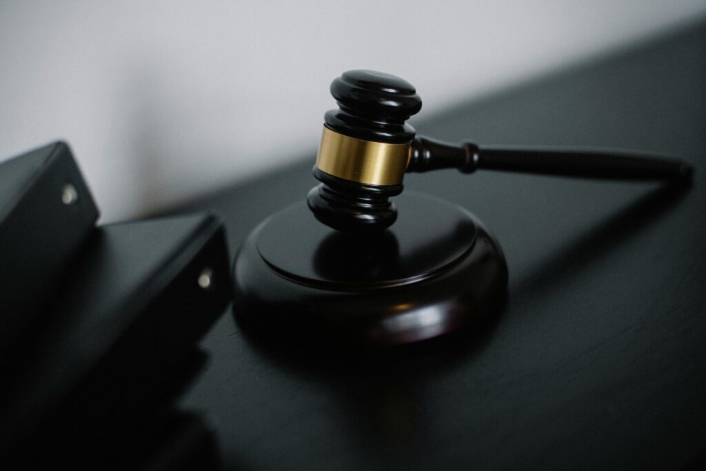 pexels-photo-5668473-5668473 Close-up of a wooden gavel on a desk, symbolizing justice and legal authority.